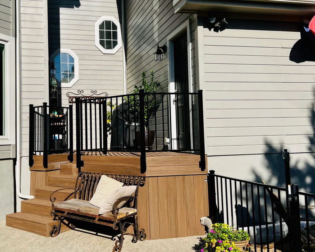 Modern horizontal iron gate and railing with adjacent composite deck and trim