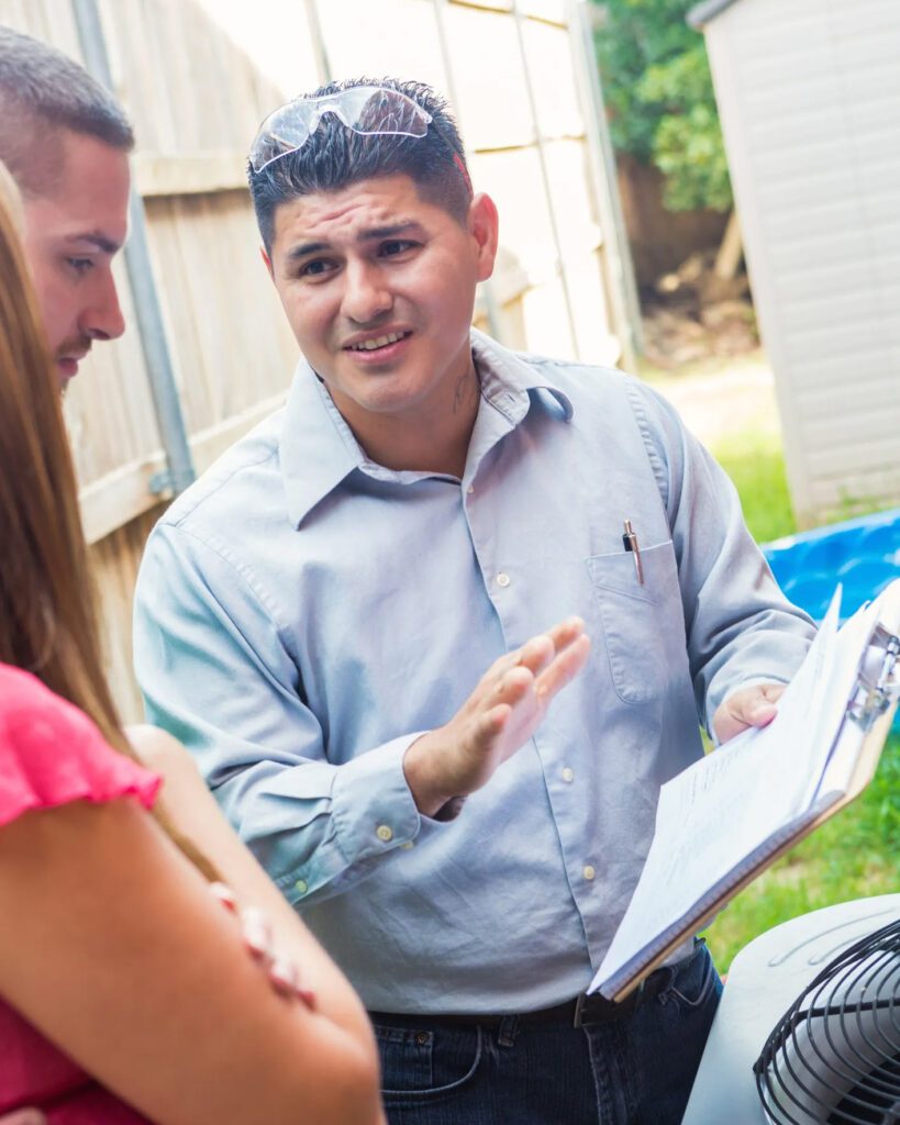 Estimator talking to homeowner during outdoor consultation