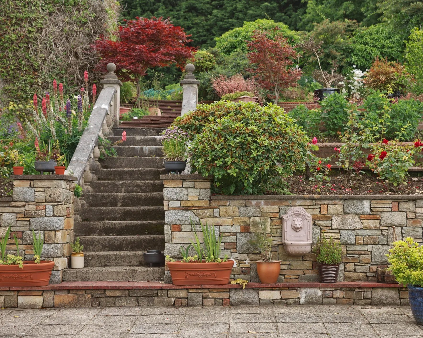 Raised stone garden planters built into terraced landscaping