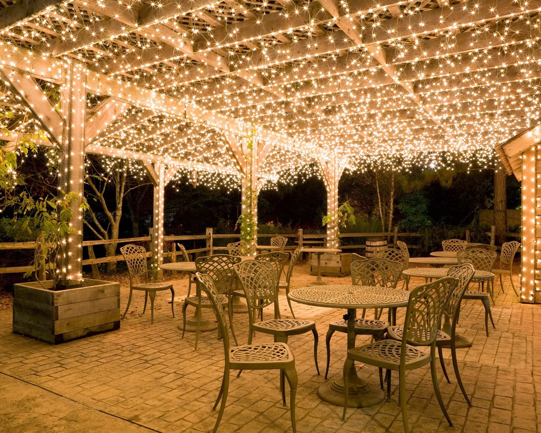 Pergolas are pretty popular in Round Rock Backyard pergola in Round Rock with string lights and a dining table underneath