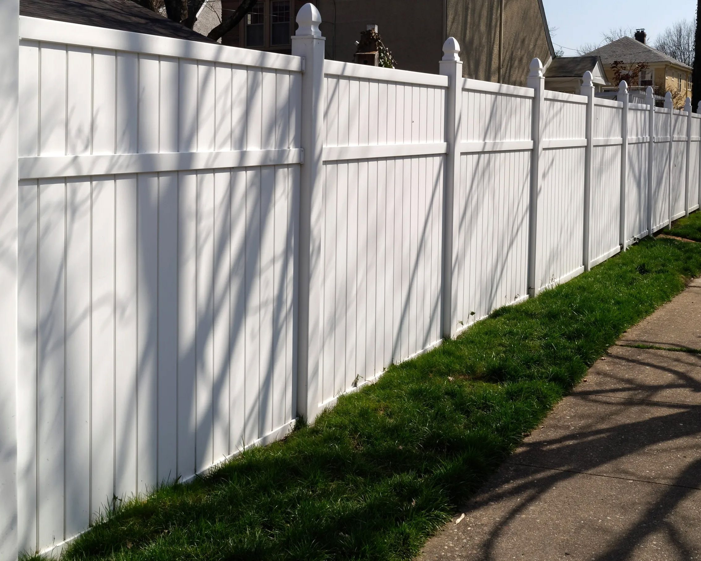 Close-up of traditional white vinyl privacy fence
