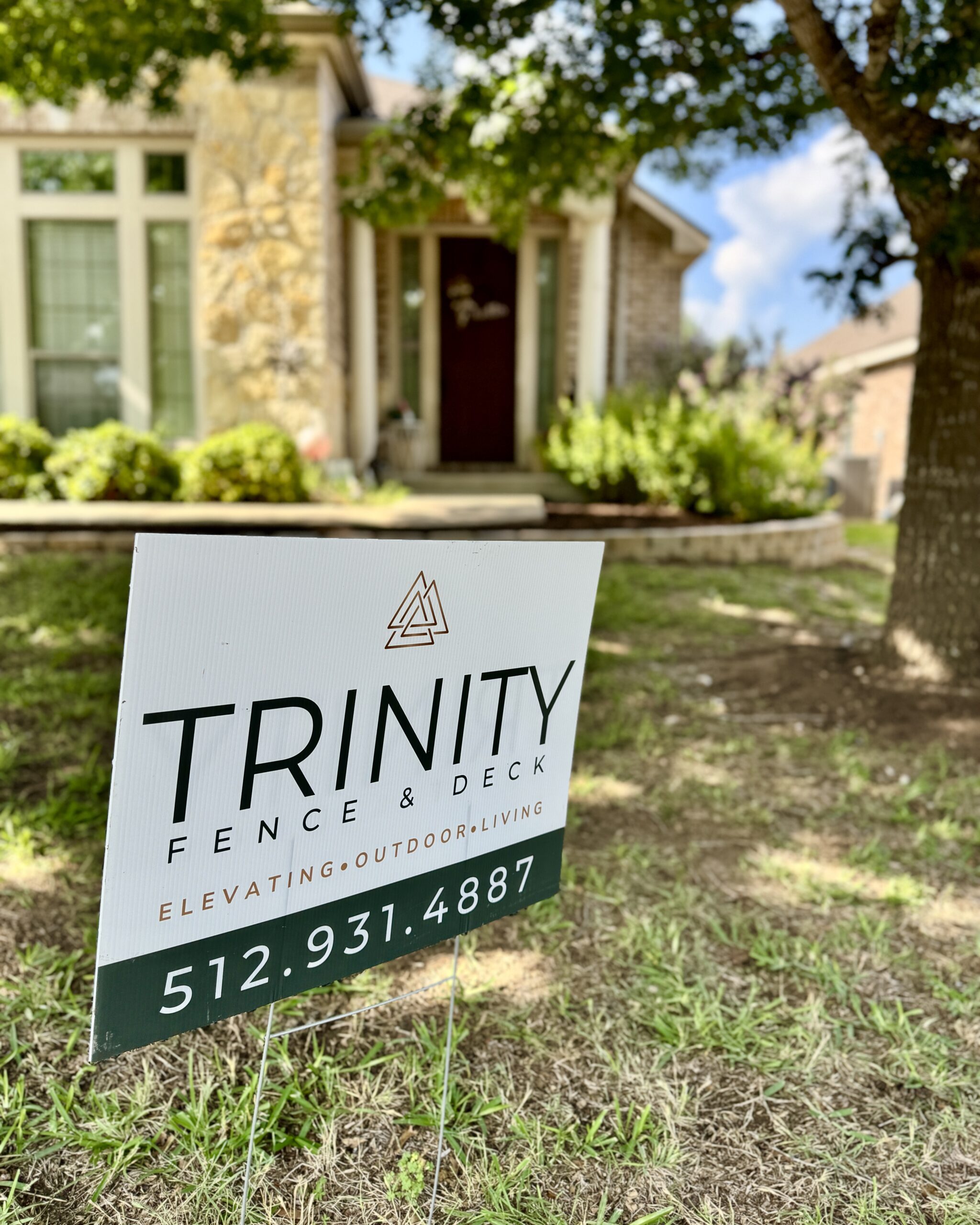 Trinity Fence & Deck yard sign displayed in front of a Central Texas home