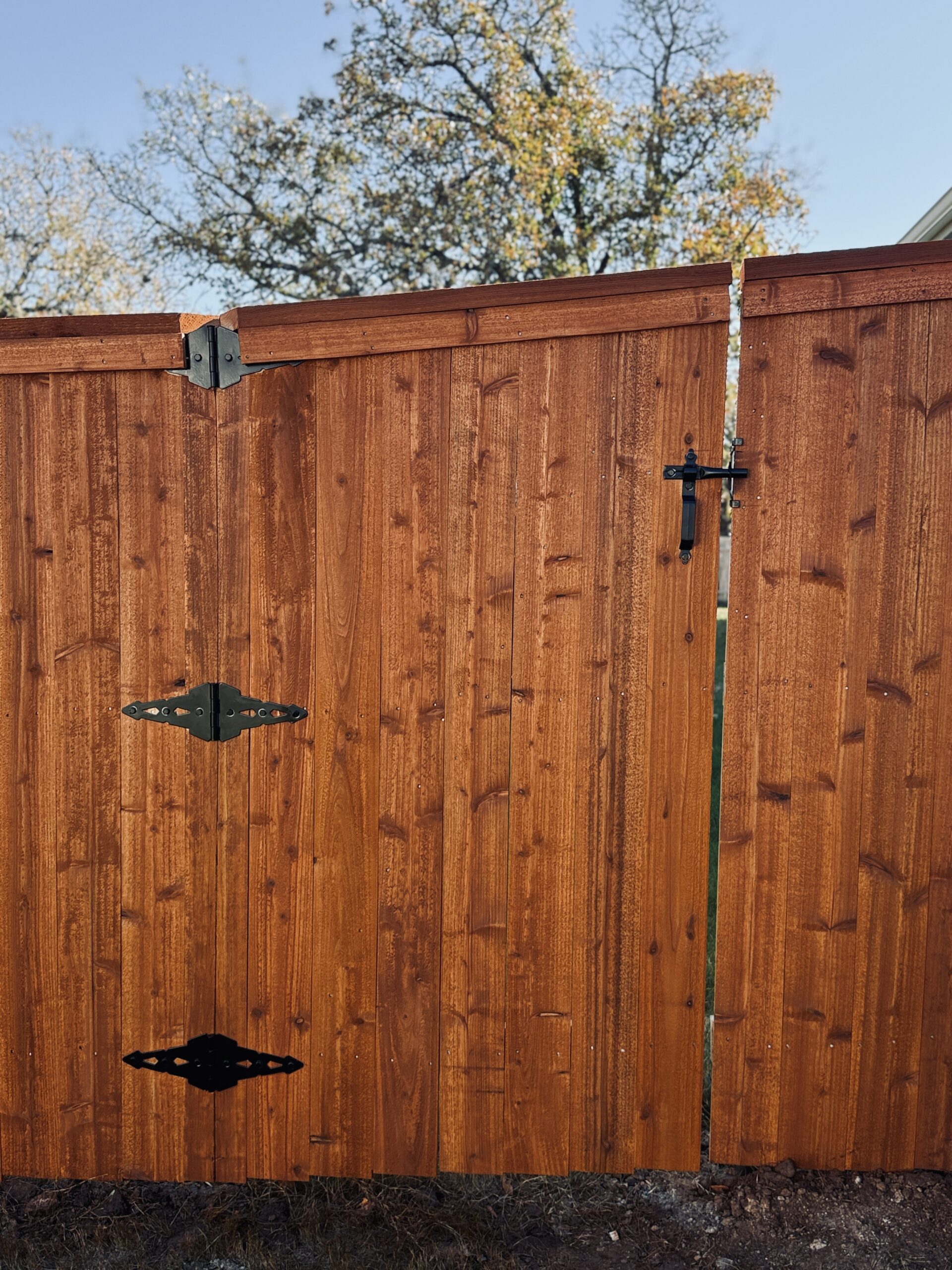 Custom cedar gate and fence panels with black hardware in Liberty Hill